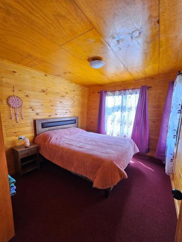 PuqueldónCasa familiar en Isla Lemuy的小木屋内一间卧室,配有一张床