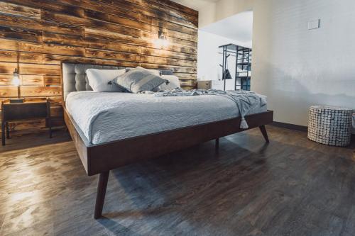 米苏拉Bel Aire Motel的一间卧室设有一张床和木墙