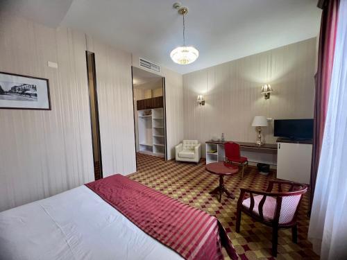 埃里温亚美尼亚皇宫酒店的配有一张床和一张书桌的酒店客房