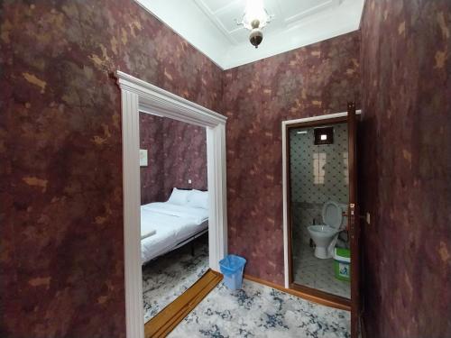 撒马尔罕Fayz Guest House的小房间设有床和镜子