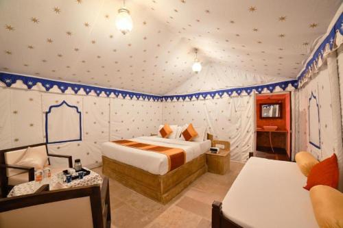 斋沙默尔Ozaki Desert Camp的卧室配有一张床铺,位于墙上的星空间