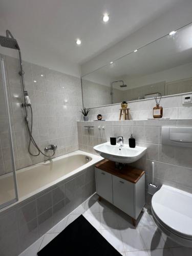 哥达CozyHome Hauptmarkt Apartment的一间带水槽、浴缸和卫生间的浴室