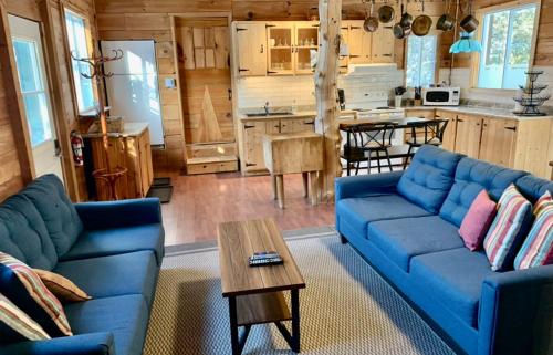 蒙特朗布朗多麦茵萨姆酒店的客厅配有蓝色的沙发和桌子
