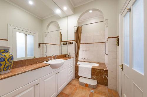 奥尔伯里Porters Cottage Oasis的一间带水槽、卫生间和镜子的浴室