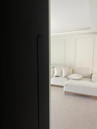 GuaramirimCasa com quarto disponível em Guaramirim的客厅配有白色的沙发和桌子