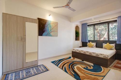 卡兰古特Rahul Service Apartment的一间卧室设有一张床和一个大窗户