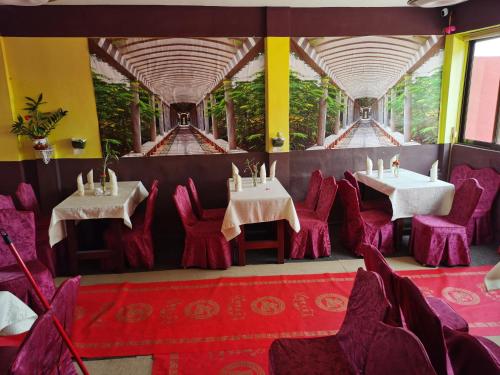 阿克拉hongyuanprimierhotel的一间在房间带两张桌子和椅子的餐厅