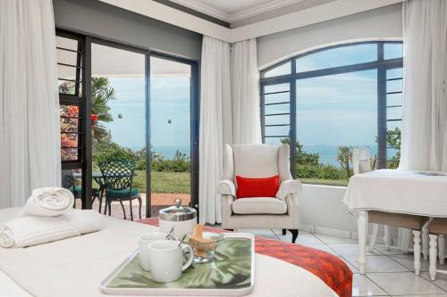 巴利托Lalaria Ocean Villa的卧室配有床、椅子和窗户。