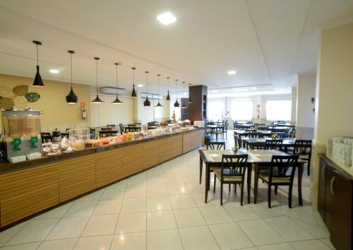 阿拉卡茹三德林普拉亚酒店的一间带桌椅的餐厅以及一间自助餐