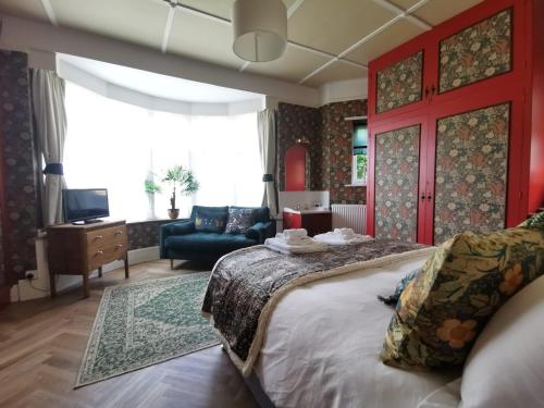 贝克斯希尔William Morris, Spacious ground floor lux double bedroom的一间带大床的卧室和一间客厅