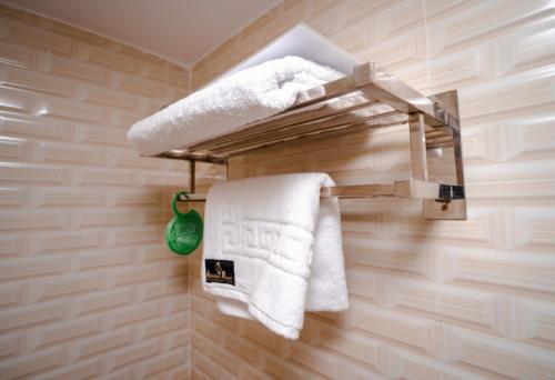 ChuknagarAdarsha Palace Hotel的浴室提供毛巾架上的白色毛巾