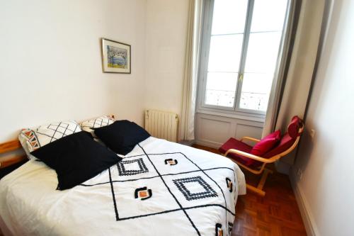 托农莱班Appartement avec vue 180 sur le Lac Léman的一间卧室配有一张带黑白棉被的床