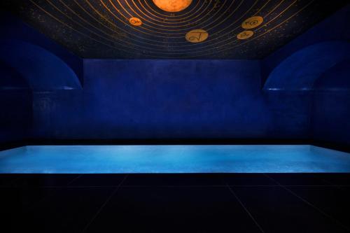 巴黎Maison Souquet, Hotel & Spa的蓝色的房间,设有浴缸,画着行星