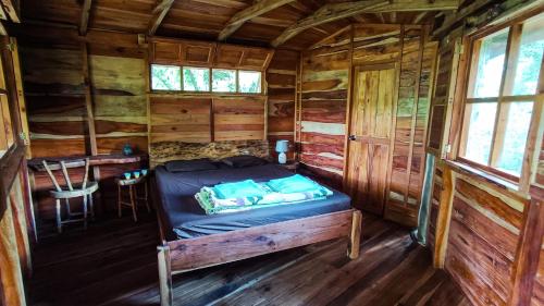 Muy MuyJungle Cabins El Escondido的小木屋内的一张床位,配有桌子