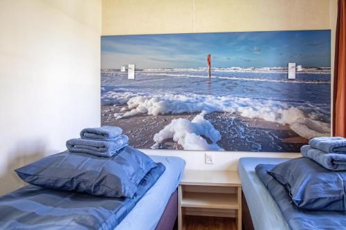 德科克斯多普Chalet de Slufter Texel的一张位于一间享有大海美景的客房内的两张床