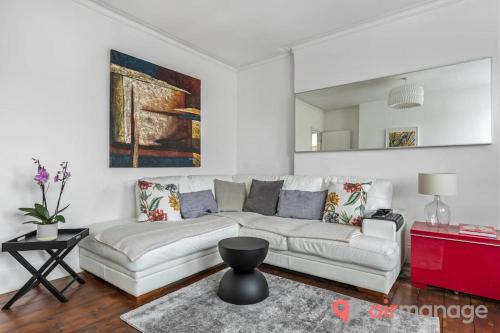 伦敦West Kensington 2Bed Flat的客厅配有白色沙发和红色桌子