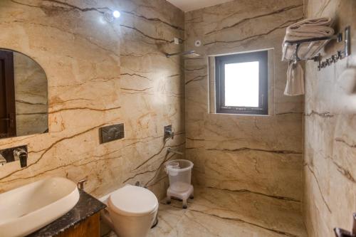 Kota BāghPitaara Cottage的石质浴室设有卫生间和水槽