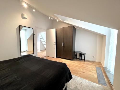 哥德堡Elegant Apartment In The Heart Of The City的一间卧室设有一张黑色的床,铺有木地板。