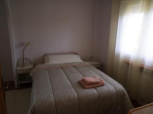 洛索亚河畔加尔甘蒂利亚Casa en Pinilla de Buitrago的一间卧室配有一张床,上面有两条毛巾