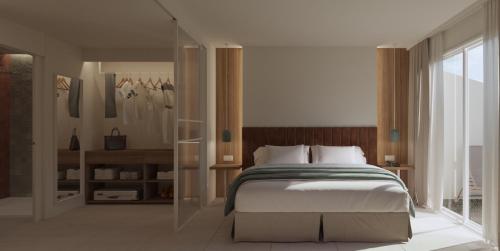 萨洛尤罗萨鲁水疗酒店的一间卧室设有一张大床和一个窗户。