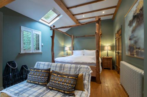 切尔滕纳姆Stable Lodge - Boutique Bed & Breakfast的一间卧室设有四柱床和窗户。