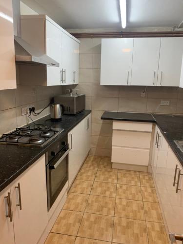 GoodmayesGoodmayes Park Home的厨房配有白色橱柜和炉灶烤箱。