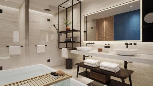 南迪Crowne Plaza Fiji Nadi Bay Resort & Spa, an IHG Hotel的浴室配有2个盥洗盆和1个浴缸。