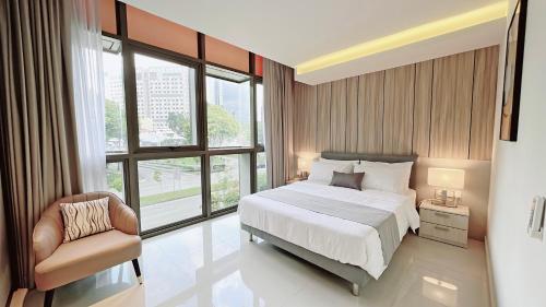 新加坡Moulmein Studios by K&C Serviced Apartment的卧室配有床、椅子和窗户。