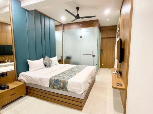 拉杰果德Hotel Royal Elite的一间卧室配有一张蓝色墙壁的床