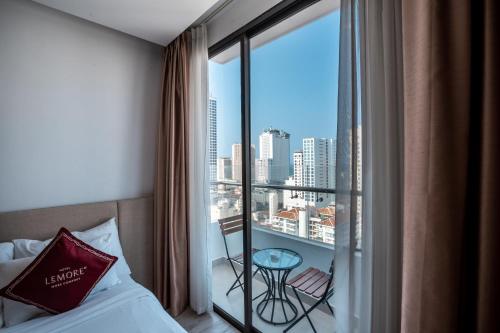 芽庄LeMore Hotel Nha Trang的酒店客房设有一张床和一个美景阳台