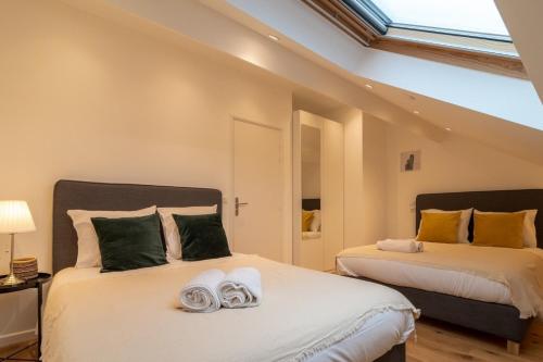 里尔Lille Centre - Nice cozy and functional ap的一间卧室配有两张带毛巾的床