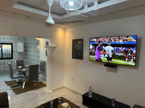 BrusubiThe Retreat Apartments的客厅的墙上配有平面电视。