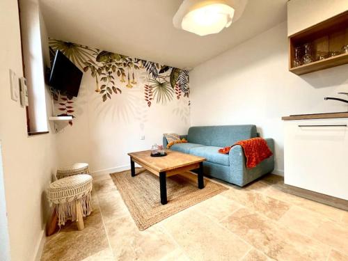 罗莫朗坦Le Nid Arrivé autonome clim wifi linge inclus的客厅配有蓝色的沙发和桌子