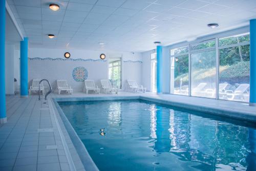 穆斯拉尔盖德Residence Le Royal Golf & Horse的蓝色柱子房子中的游泳池