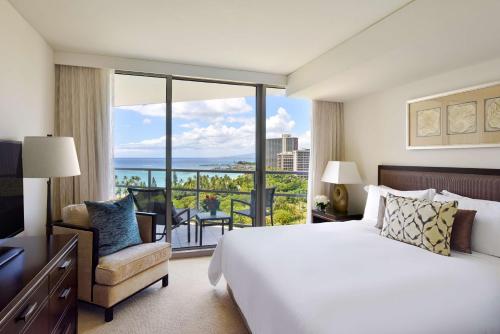 檀香山Ka Laʻi Waikiki Beach, LXR Hotels & Resorts的酒店客房设有一张大床和一个阳台。