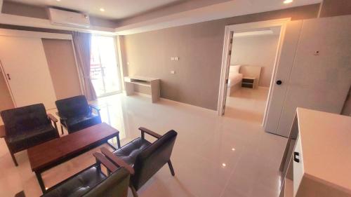 邦帕利PKK hotel Residence的客厅配有椅子、桌子和沙发