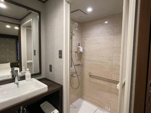 宫岛菊野屋酒店的带淋浴和盥洗盆的浴室