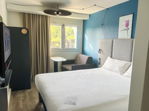 尼姆宜必思尼姆西部酒店 - A9 的配有一张床和一把椅子的酒店客房