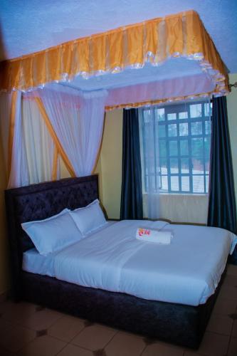 Emarah Getaway Sagana客房内的一张或多张床位