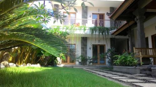 勒吉安库布卡里克酒店的前面有棕榈树的房子
