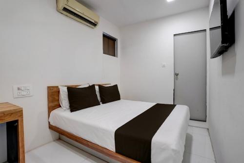 孟买OYO Hotel Vrindavan Residency的一间白色客房内的床铺卧室