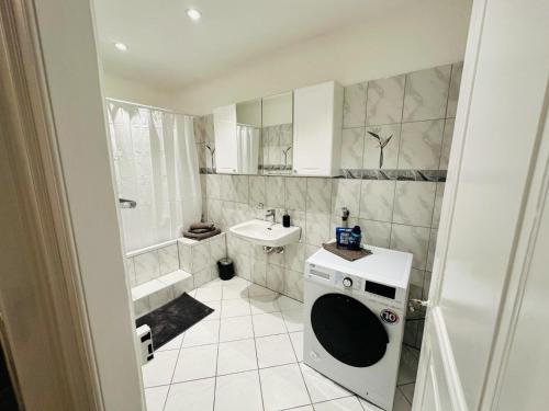 乌斯特Exclusive apartment for families and business的一间带洗衣机和水槽的浴室