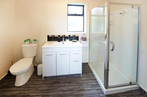 罗托鲁瓦大使温泉汽车旅馆的浴室配有卫生间、盥洗盆和淋浴。