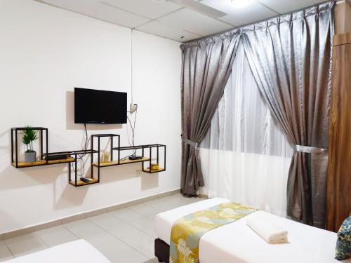 Kota BharuSalaam Suites Hotel的客房设有床、电视和窗户。