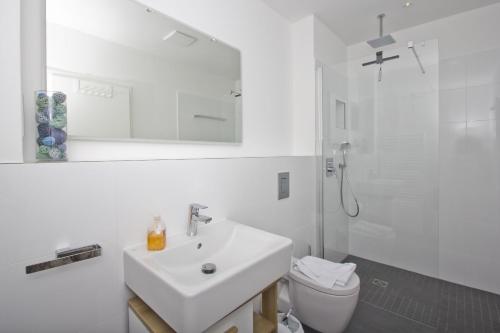 格罗斯齐克Haus Inselwind FeWo 09 MEERzauber - Terrasse的白色的浴室设有水槽和卫生间。