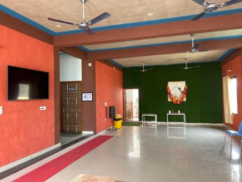 KhātuPrem Bhawan Guest House的大房间设有红色的墙壁和平面电视