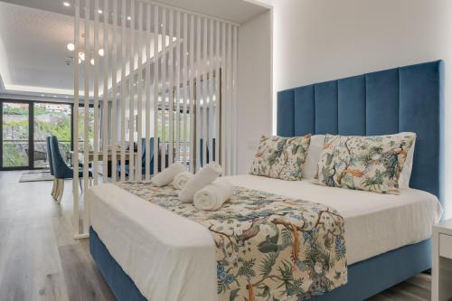 卡马拉-德洛布什Torre Palace II by Atlantic Holiday的一间卧室配有一张大床和蓝色床头板