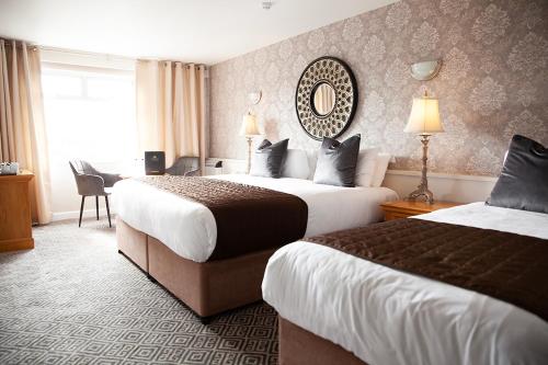 穆林加尔马林加格雷维尔武器酒店的酒店客房,设有两张床和镜子