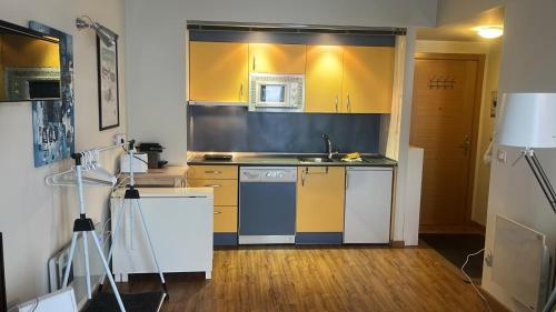坎丹奇奥Apartamento Riglos2 Candanchu的厨房配有黄色橱柜和水槽
