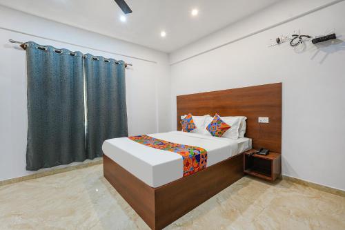 班加罗尔FabHotel Tree Suites的一间卧室设有一张大床和一个窗户。